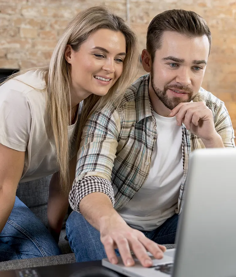 Couple focused on laptop